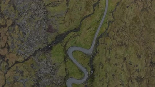 Aerial view of a winding road in the Faroe Islands landscape