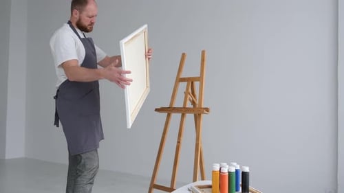 A Creative Artist Paints a Creative Picture on a Canvas The Process of Painting in the Workshop