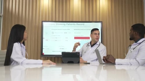 Doctors Meeting to Review Patient Healthcare Records