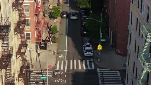 Aerial View of a Bustling New York City Street Highlighting the Iconic Red Brick Buildings Cycle
