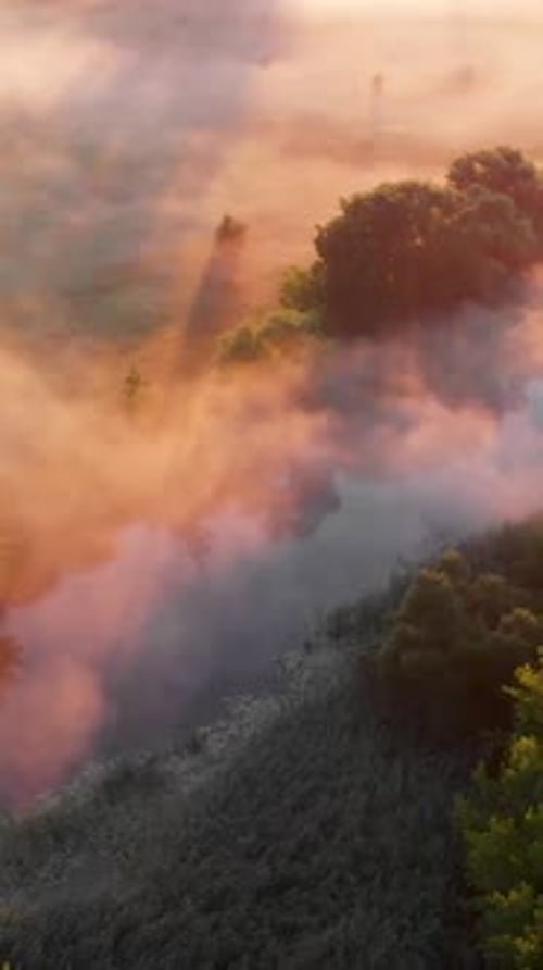 Aerial Drone View of Sunrise Over Misty River
