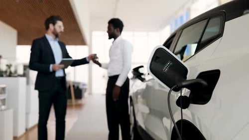 Dealer Sells Electric SUV to Businessman in Car Dealership