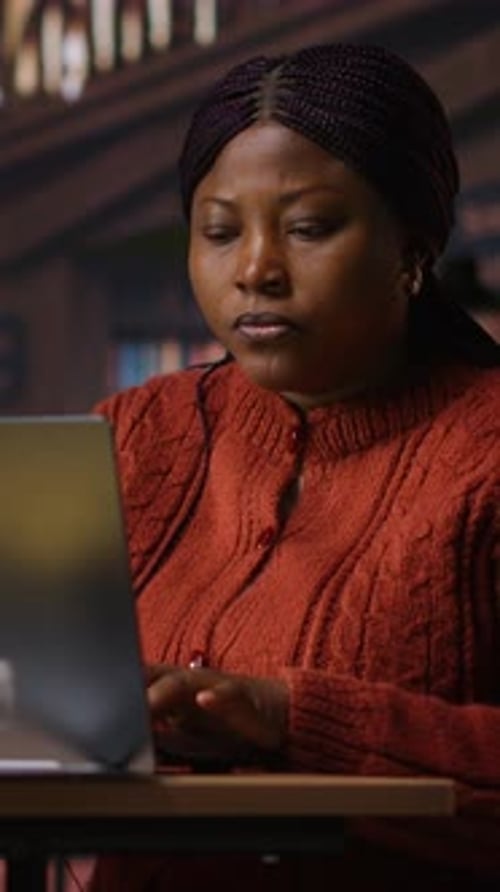 Vertical Video African American Tutor Preparing Documents and Learning Materials for Teaching