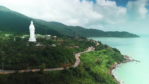 Lady buddha statue and linh ung pagoda complex rising on a lush son tra peninsula mountain slope