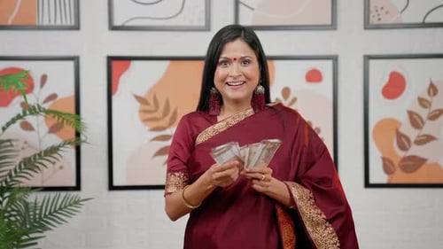 Woman Smiles and Counts Cash Indoors