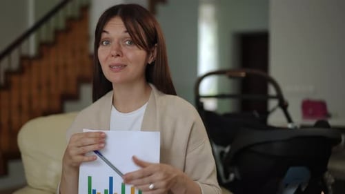 Woman Explaining Graph with Pen Indoors at Home