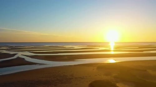 Cape Cod Bay Beach at Low Tide During Golden Hour, Bright Sun Low and Setting, Pan Right