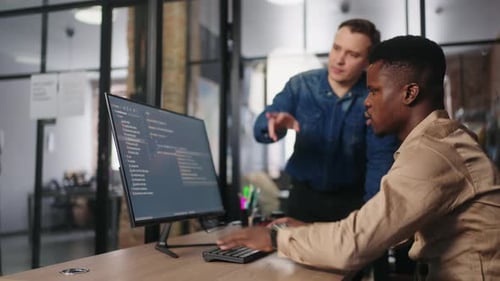 Team von Büroangestellten diskutiert über das Projekt Multiethnische Männer schauen auf den Bildschirm eines Computers
