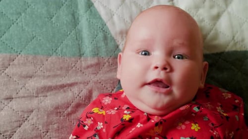 Portrait of a Cute Little Baby Girl Lying on the Bed