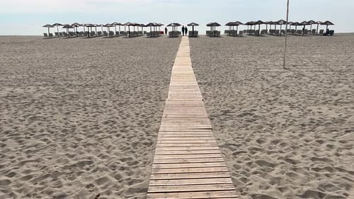Peaceful June morning on the beach in front of Dion Palace Resort, Greece. Empty beach with umbrella