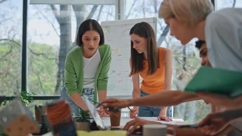 Diverse Group Discussing Work Project in Meeting Room Team Talking Together