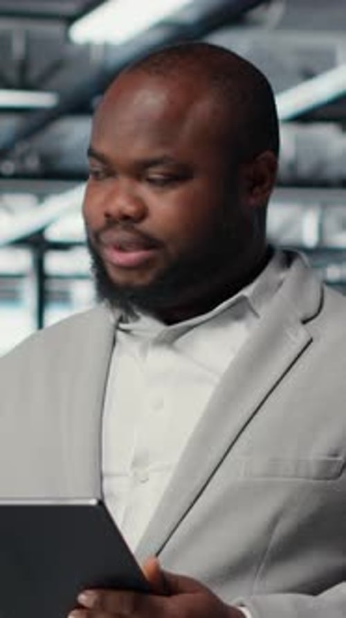 Man in Suit Using Tablet in Office Setting