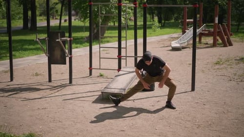 Playground Athlete Warming Up With Dynamic Leg Stretches Preparing For Calisthenics Routine On Sandy