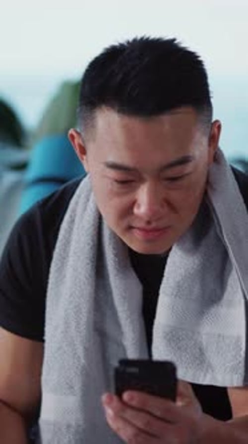 Young Adult Using Phone After Exercise