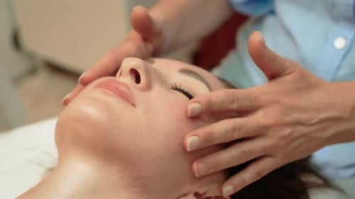 Woman Receiving Relaxing Facial Massage Treatment