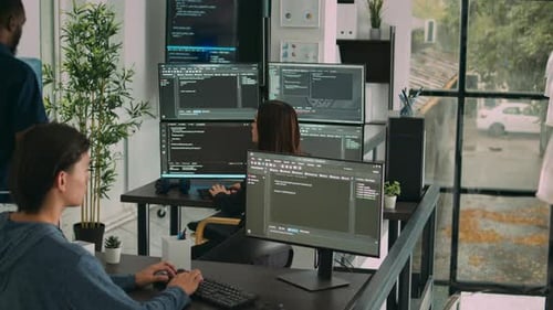 Diverse Team of Database Developers Analyzing Code on Terminal Window
