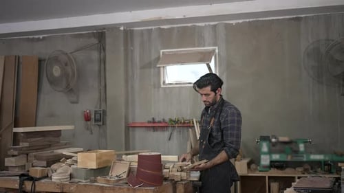 Carpenter is working at workshop.
