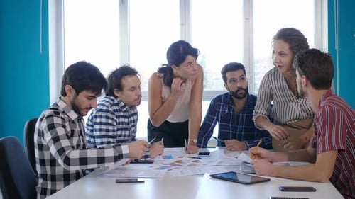 Diverse Team Discussing Business Strategy in Modern Office