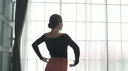 Friends practice ballet dance at studio.