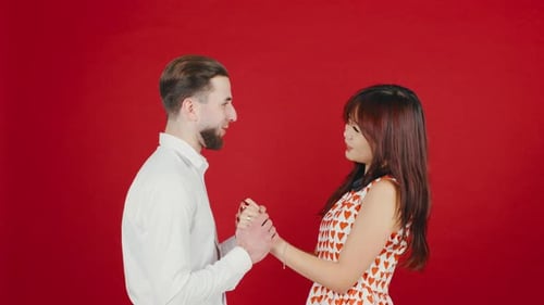 Joyful Couple Holds Hands in Romantic Engagement Moment