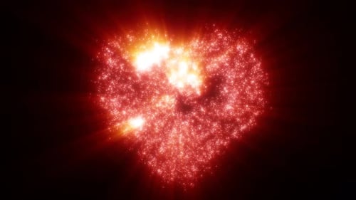 Abstract red love heart made of small bright glowing particles of energy festive background
