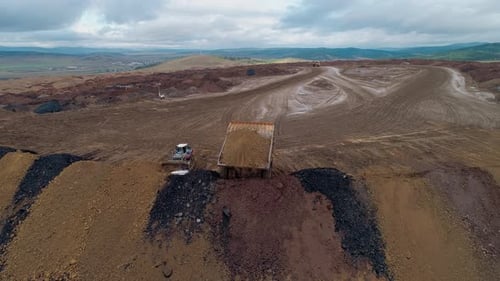 Panoramaaufnahme eines Kohlebergbaus, schwere Bergbaumaschinen und Muldenkipper in einem Steinbruch