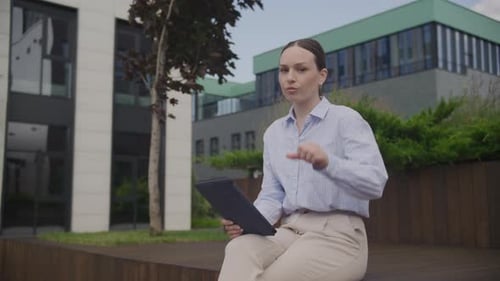 Woman With Tablet Gives Thumbs Down Gesture Outdoors
