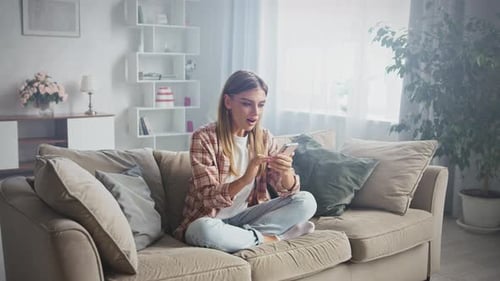 Excited Woman Celebrating Good News on Smartphone