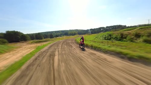 Motocross Rider on Dirt Bike Course on Sunny Day