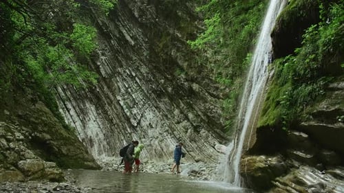 Scenic Waterfall With Family in Green Nature Setting
