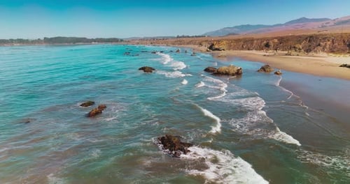 Calming pleasant view of waves moving to the shore. Pacific ocean coastline at Morro Bay, California