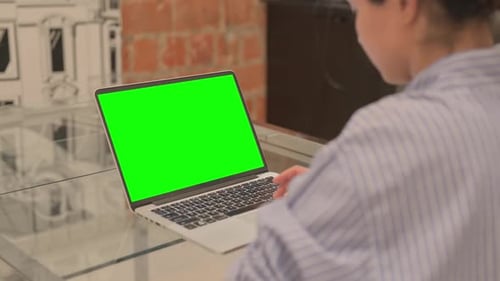 Businesswoman Using Laptop with Green Screen
