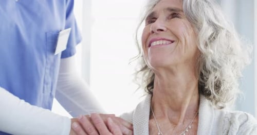 Caring Nurse with Senior Woman in Hospital