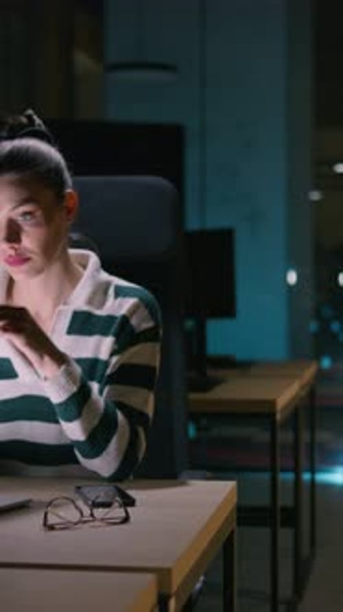 Female Businesswoman Employee Working Late in the Office Using a Laptop While Feeling Tired and