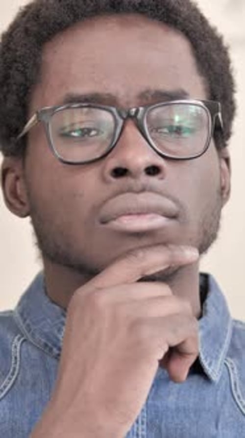 Pensive Man with Glasses Contemplating Decisions