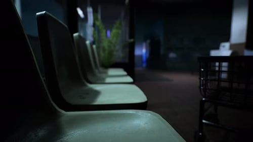 Moving Shadows Across Empty Chairs in Dark Interior