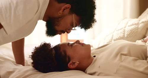 Affectionate Couple Sharing Intimate Moment on Bed