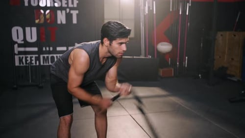 Sport man Workout Exercise with Battle Rope Training Building Muscles and Burning Fat Cardio