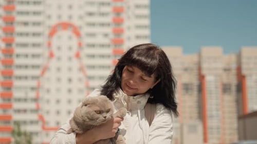 Woman Cuddling Cat Brightly Colored City Background With Woman And Her Pet Feline Peaceful Moment Of