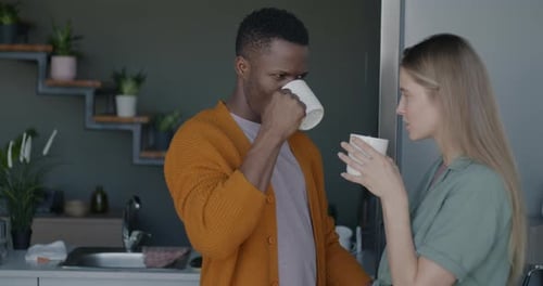 Man and Woman Talking and Drinking Beverages