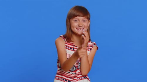 Happy Girl Expressing Love Against Blue Background