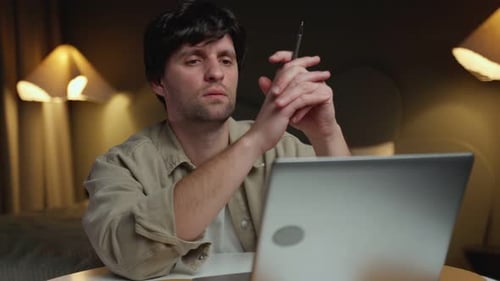 Pensive Man with Laptop Thinking Deeply