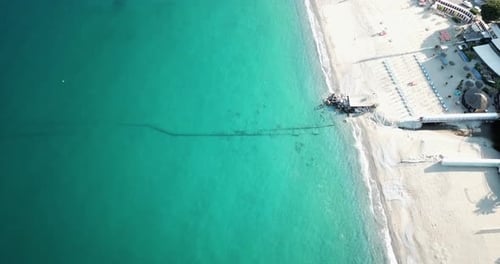 Blue Mediterranean sea view by an drone aerial shot, sandy beach, genoa, Italy