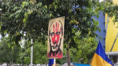 Controversial Sign with Flags Outdoors Daytime
