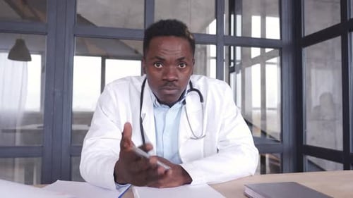 Black Male Doctor Talking To Web Cam Consulting Patient Via Virtual Telemedicine Advice. African ...