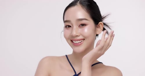Slow motion of beautiful young Asian girl with k-beauty make up style.