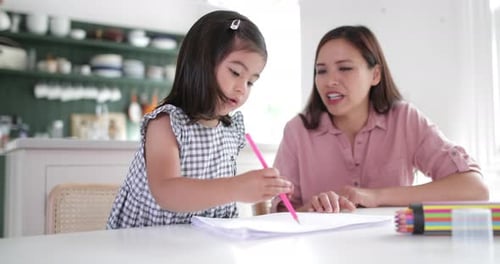 Child Drawing with Mother in Kitchen