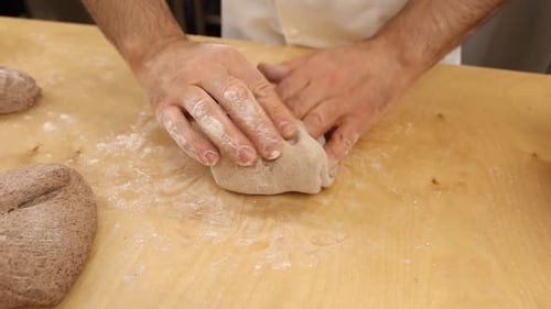 a chef makes bread in a bakery