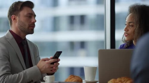 Multi Racial Couple Business People Talk Using Phone Laptop in Office Cafe