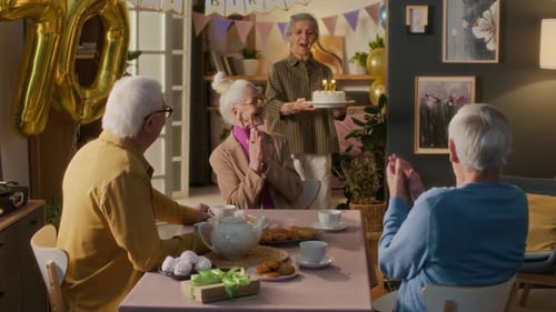 Seniors Celebrating Birthday with Tea and Cake